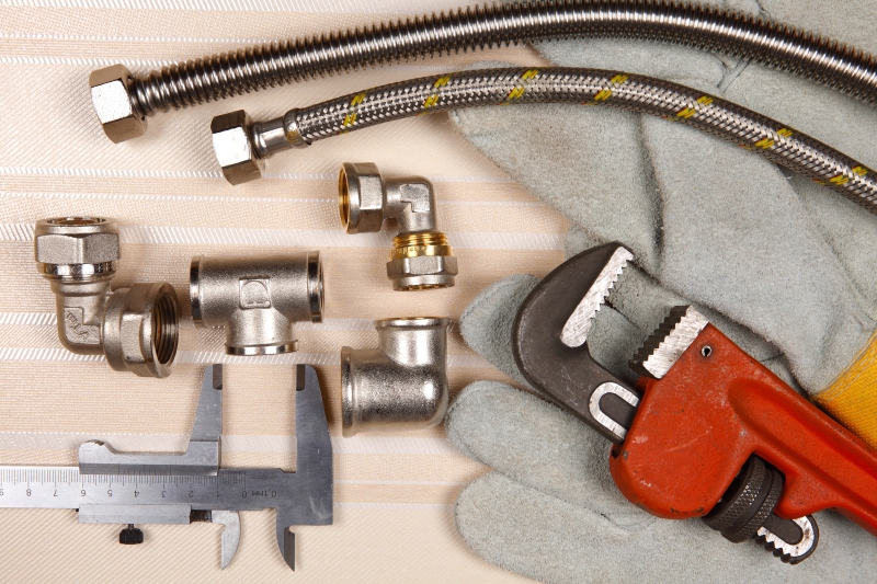 Plumber working on pipes in a Highgate home
